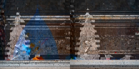 bag of waste in dumpster